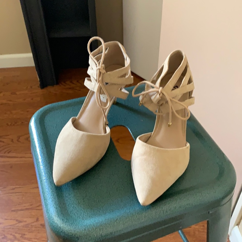 Tan colored, tie-able heels about one inch.5 tall in height. Soft material
